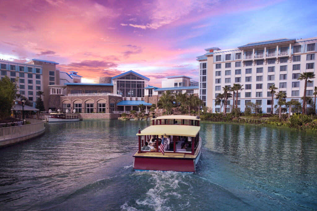 Taxi acuático con un hotel de fondo. Es un beneficio de hospedarse en un hotel de Universal Orlando Resort